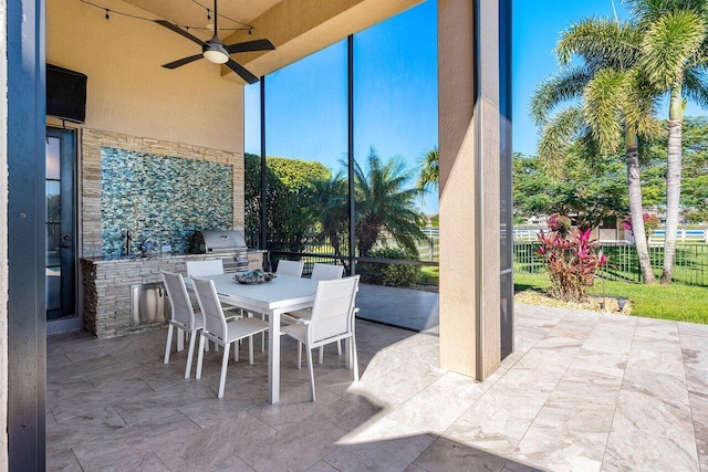 view of patio / terrace with ceiling fan, exterior kitchen, and grilling area