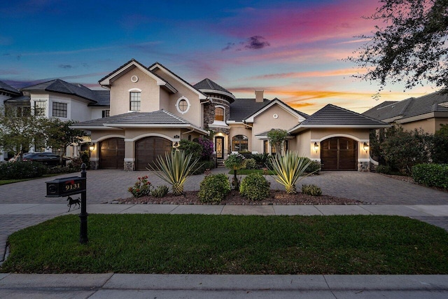 view of front facade featuring a lawn and a garage