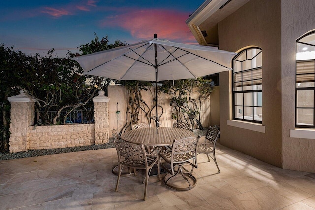 view of patio terrace at dusk