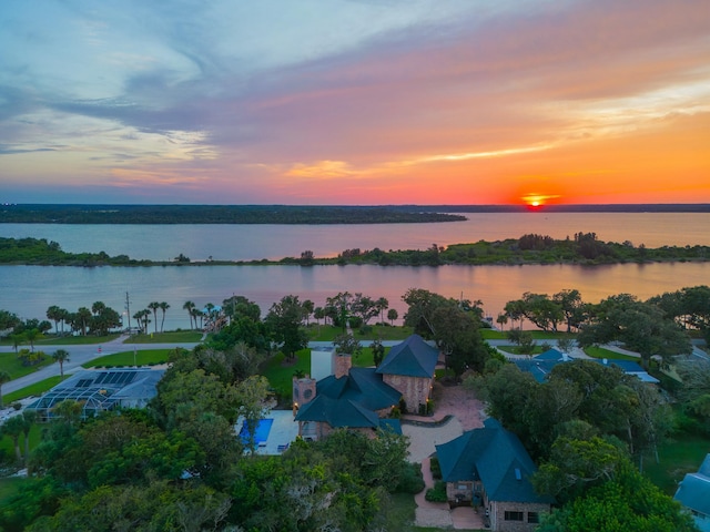 aerial view at dusk with a water view