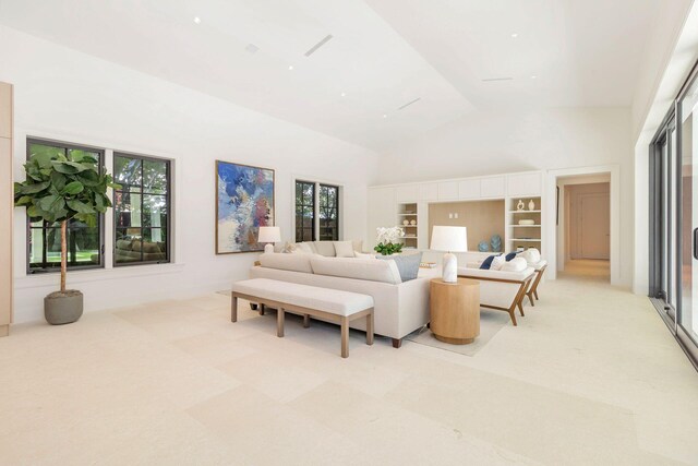 empty room featuring high vaulted ceiling, ceiling fan, and a healthy amount of sunlight