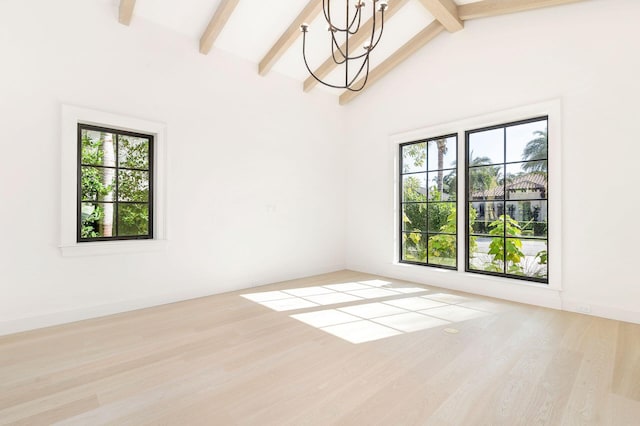 spare room with high vaulted ceiling, a notable chandelier, light hardwood / wood-style floors, and beamed ceiling