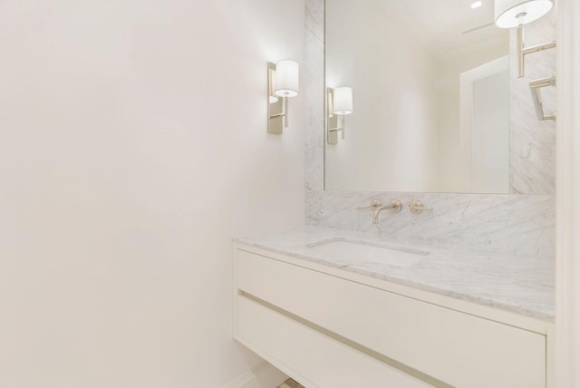 bathroom with crown molding and vanity