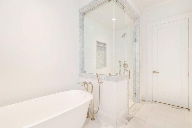 bathroom with ornamental molding and independent shower and bath