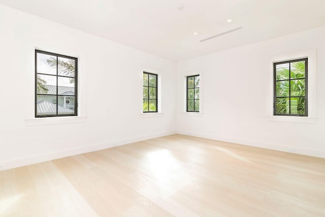 empty room with light wood-type flooring and a healthy amount of sunlight