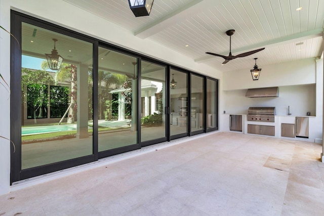 unfurnished living room featuring a healthy amount of sunlight, wooden ceiling, ceiling fan, and beamed ceiling