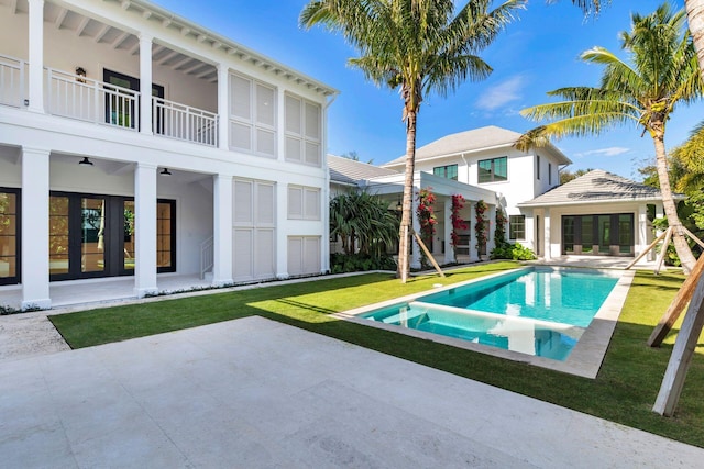 view of pool featuring a patio area, ceiling fan, and a yard