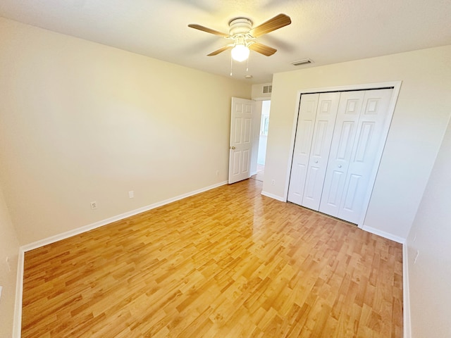 unfurnished bedroom featuring a closet, ceiling fan, and light hardwood / wood-style flooring