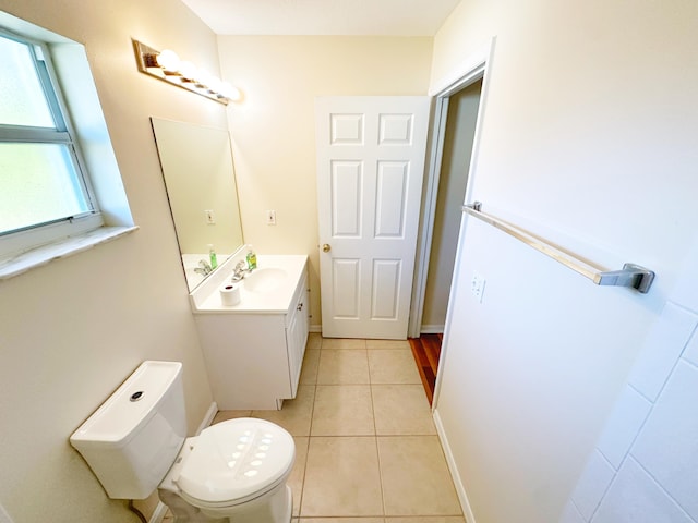 bathroom featuring vanity, toilet, and tile patterned flooring