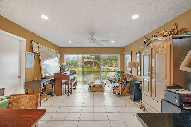 interior space with ceiling fan, light tile patterned floors, and a textured ceiling