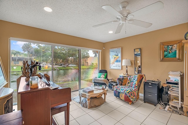 interior space with ceiling fan and a water view