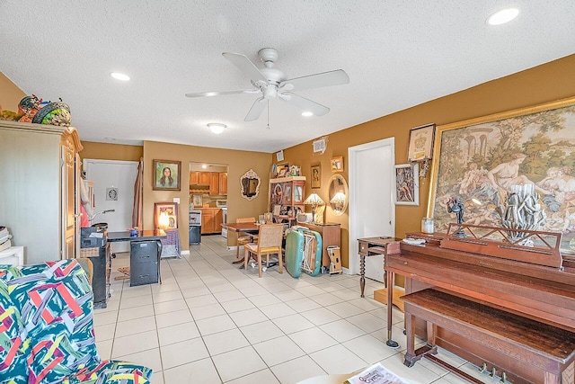 misc room featuring light tile patterned floors, a textured ceiling, and ceiling fan