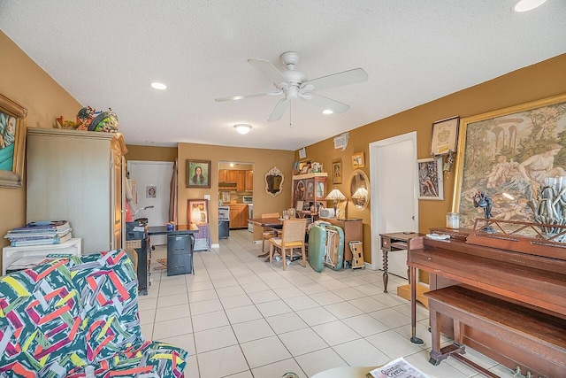 tiled living room with ceiling fan and a textured ceiling