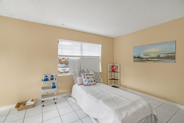 tiled bedroom with a textured ceiling