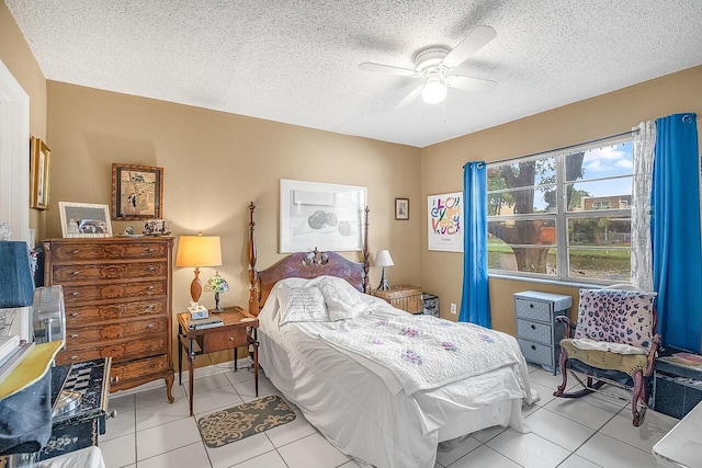 tiled bedroom with ceiling fan and a textured ceiling