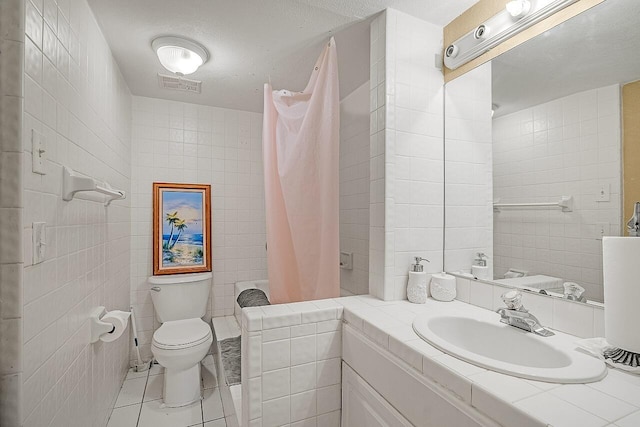 bathroom featuring walk in shower, tile walls, tile patterned floors, and toilet