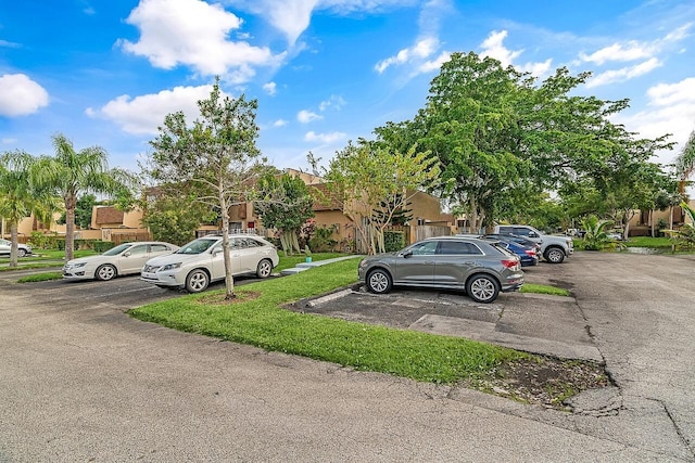 view of parking featuring a yard