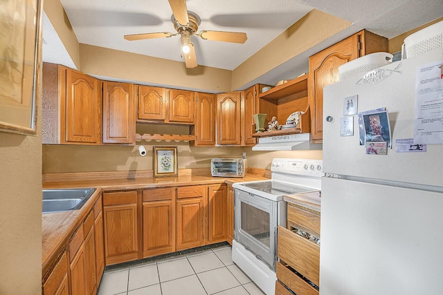 kitchen with ceiling fan, sink, light tile patterned flooring, and white appliances