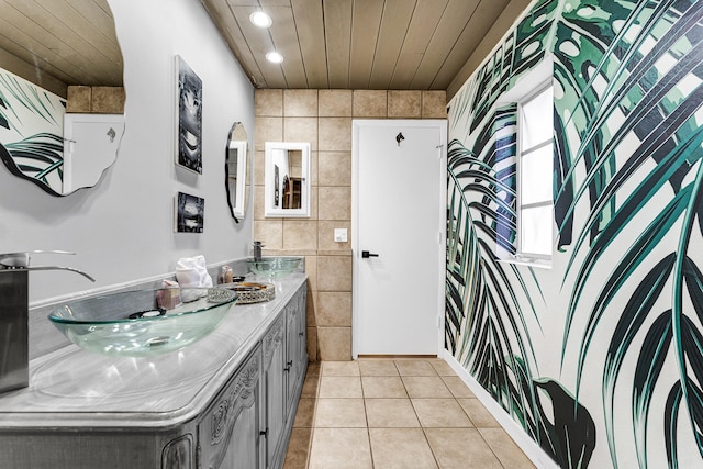 bathroom with tile patterned floors, vanity, and tile walls