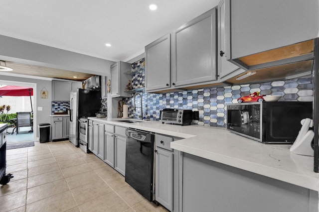 kitchen featuring tasteful backsplash, sink, dishwasher, gray cabinets, and light tile patterned flooring