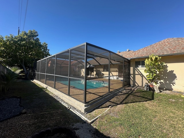 view of swimming pool featuring a lanai and a yard