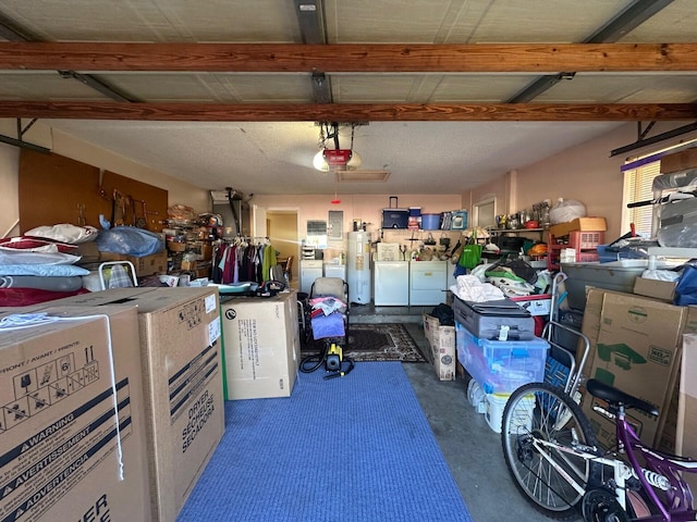 garage with electric water heater, washer and clothes dryer, and a garage door opener