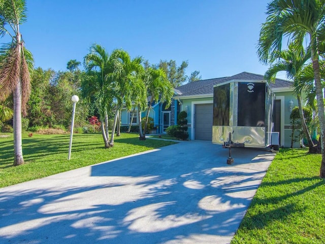 view of front of house featuring a garage and a front lawn