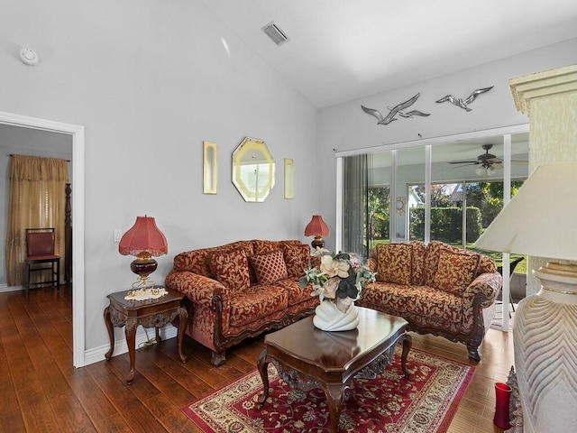 living room featuring ceiling fan and dark hardwood / wood-style floors