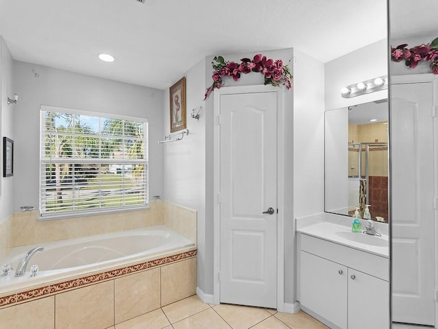 bathroom with tile patterned flooring, vanity, and separate shower and tub