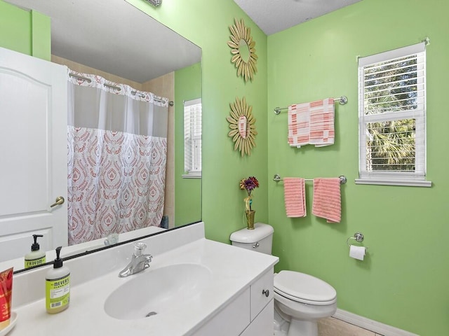 bathroom featuring vanity, a shower with shower curtain, and toilet