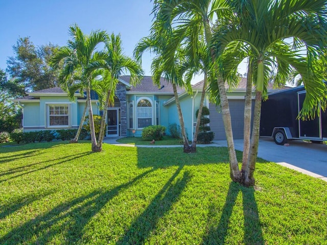 view of front of home with a garage and a front lawn