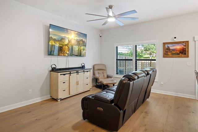 living room featuring light hardwood / wood-style flooring and ceiling fan