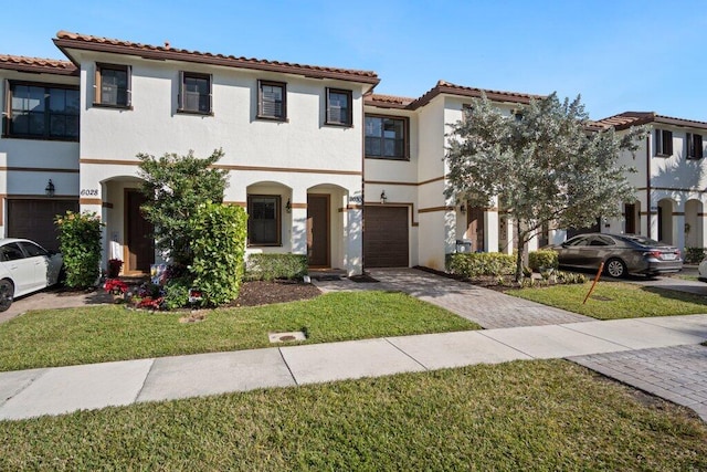 mediterranean / spanish home with a garage and a front yard