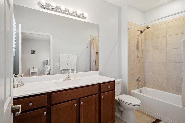 full bathroom with vanity, tile patterned floors, tiled shower / bath combo, and toilet