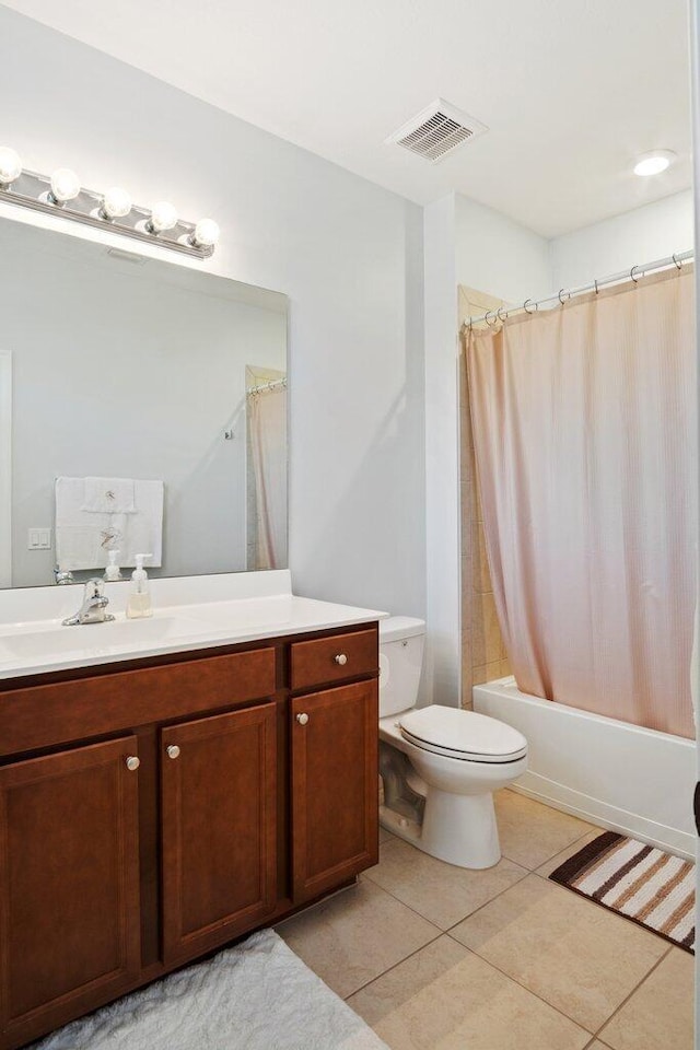 full bathroom with tile patterned flooring, vanity, shower / tub combo with curtain, and toilet