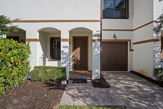 view of exterior entry with a garage