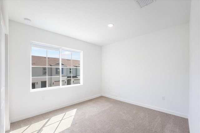 unfurnished room with light colored carpet