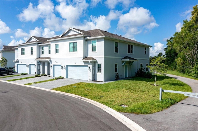 view of front of property featuring a garage and a front lawn