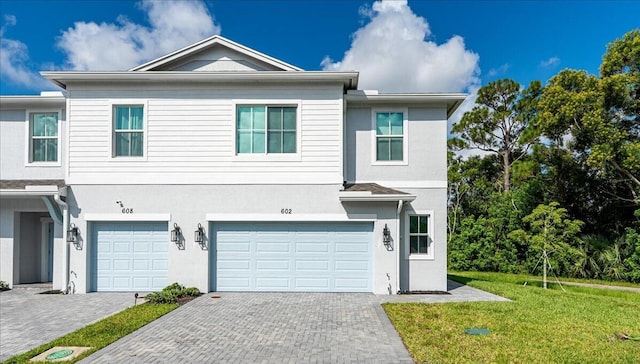 view of front of home with a garage and a front yard