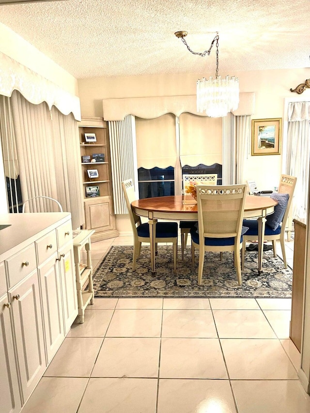 tiled dining space with a chandelier and a textured ceiling