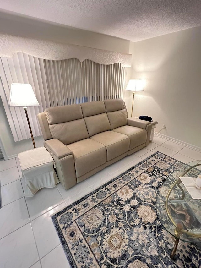 living room featuring light tile patterned flooring and a textured ceiling