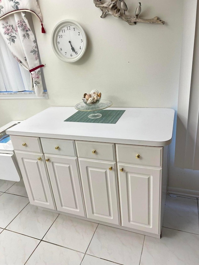 bathroom with tile patterned floors and vanity