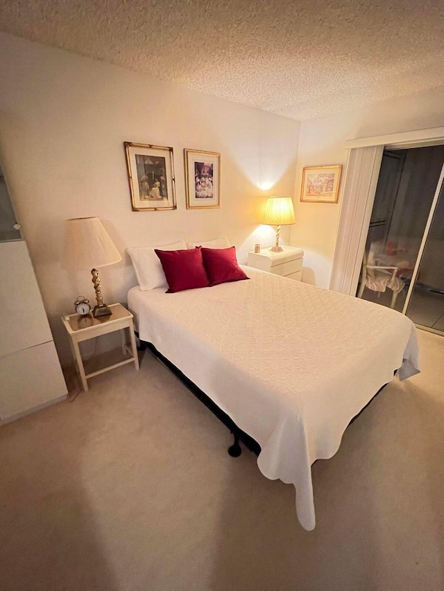 carpeted bedroom featuring a textured ceiling