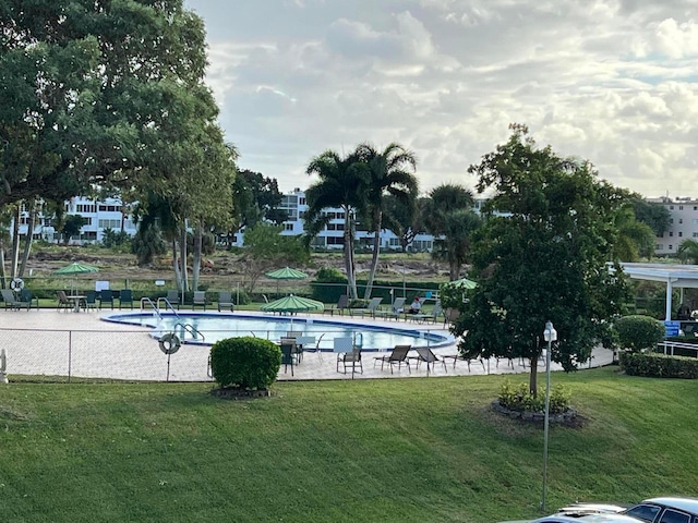 view of swimming pool featuring a lawn