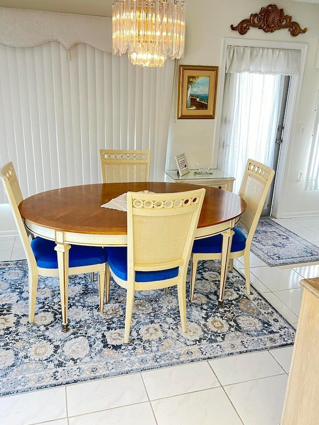 dining room featuring tile patterned flooring and an inviting chandelier