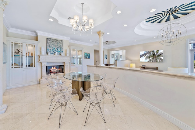 dining area with a tray ceiling, decorative columns, an inviting chandelier, and ornamental molding