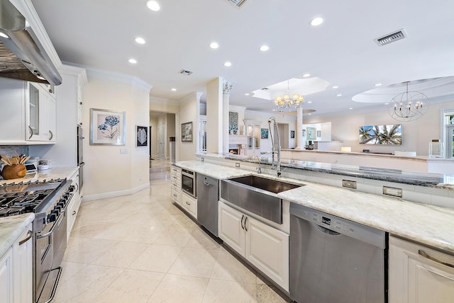 kitchen featuring white cabinetry, a chandelier, and stainless steel appliances