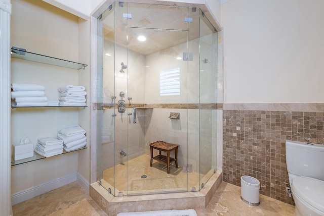 bathroom featuring an enclosed shower, toilet, and tile walls