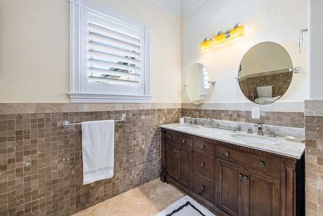 bathroom with vanity, tile patterned floors, toilet, ornamental molding, and tile walls