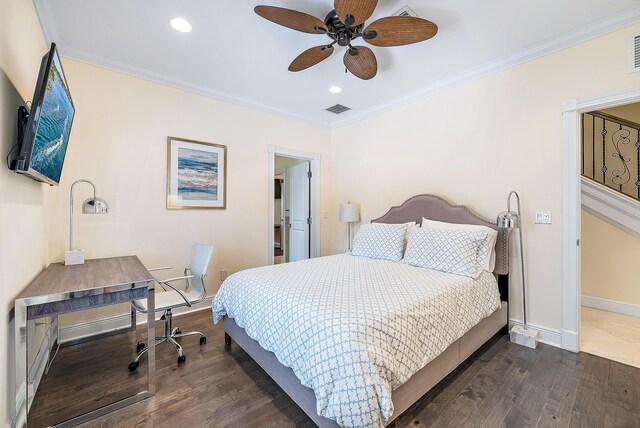 bedroom featuring dark hardwood / wood-style flooring, ceiling fan, and ornamental molding